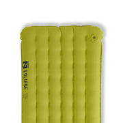 A green lightweight Eclipse™ All-Season Insulated Sleeping Pad by NEMO Equipment, featuring vertical air chambers, a valve at the top right, and the brand name printed on the left side.