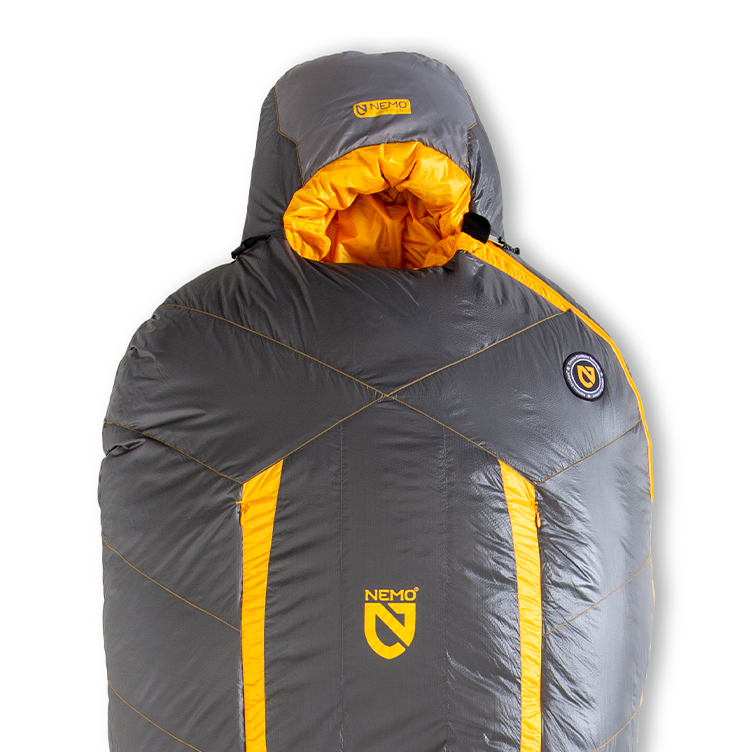 The NEMO Equipment Sonic™ Down Mummy Sleeping Bag, shown upright in gray and yellow with a hood, features hydrophobic down for extreme warmth. The NEMO logo appears on the front center and near the right shoulder.