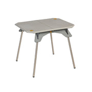 The Moonlander™ Dual-Height Camp Table, by NEMO Equipment, is a compact, portable folding table with a gray top and metal legs. Its versatile dual-height design makes it an ideal addition to any camp kit for various outdoor adventures.