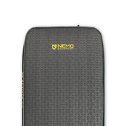 Close-up of a gray NEMO Equipment Roamer™ Self-Inflating Mattress featuring a textured hexagonal pattern and yellow logo near the top center.
